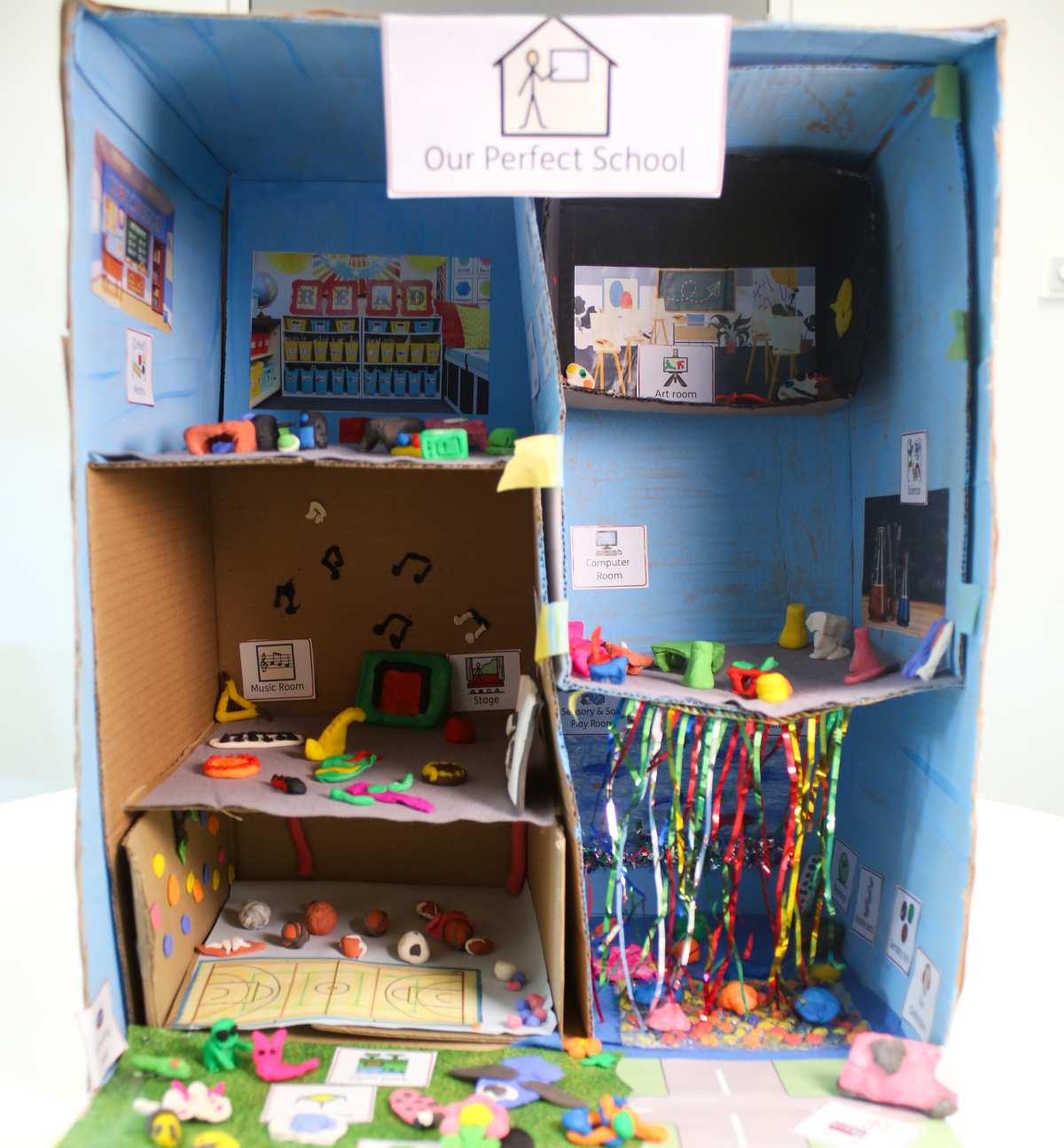 School made out of cardboard and clay, titled Our perfect school, artwork by child in SEND provision