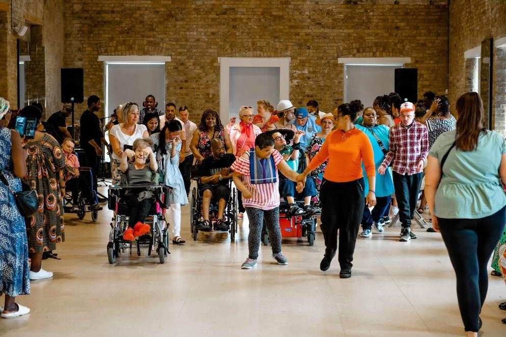 group of children with mixed disabilities aged 7-9 in party clothes having fun