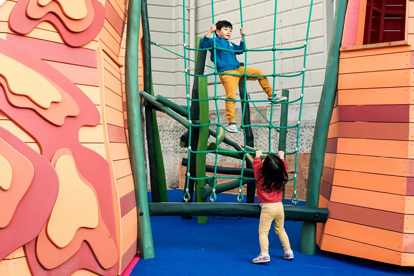 two children climbing on a rope ladder