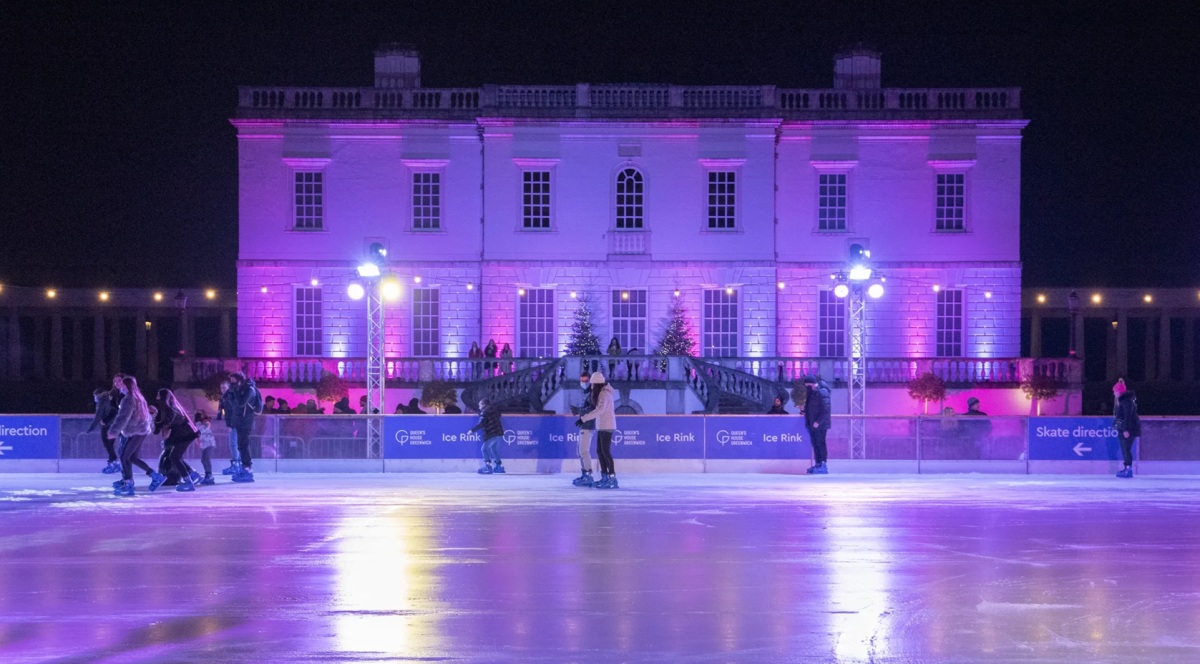 Queen's House Ice Rink with rink in background, lit up purple and blue, quite empty rink