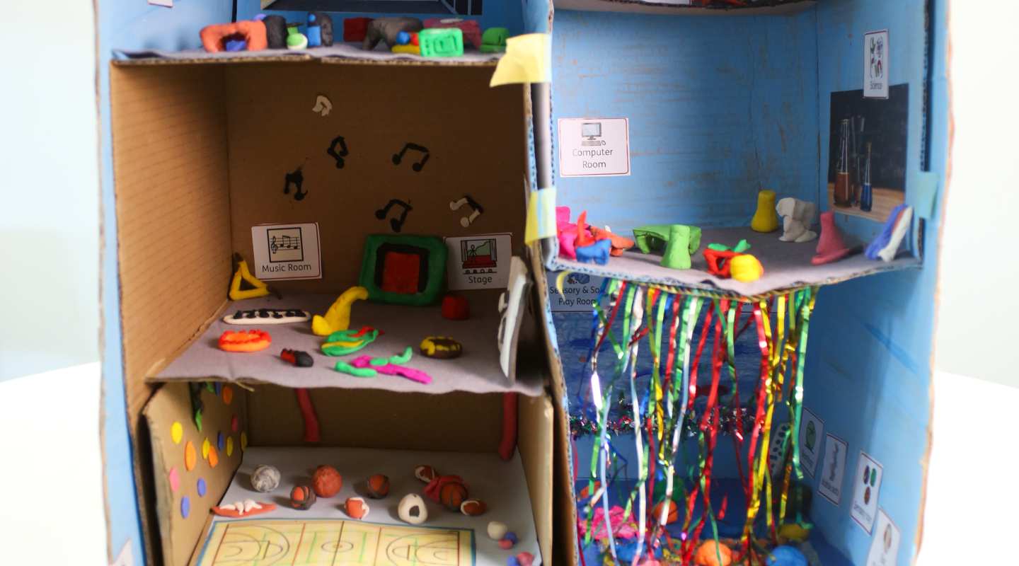 School made out of cardboard and clay, titled Our perfect school, artwork by child in SEND provision