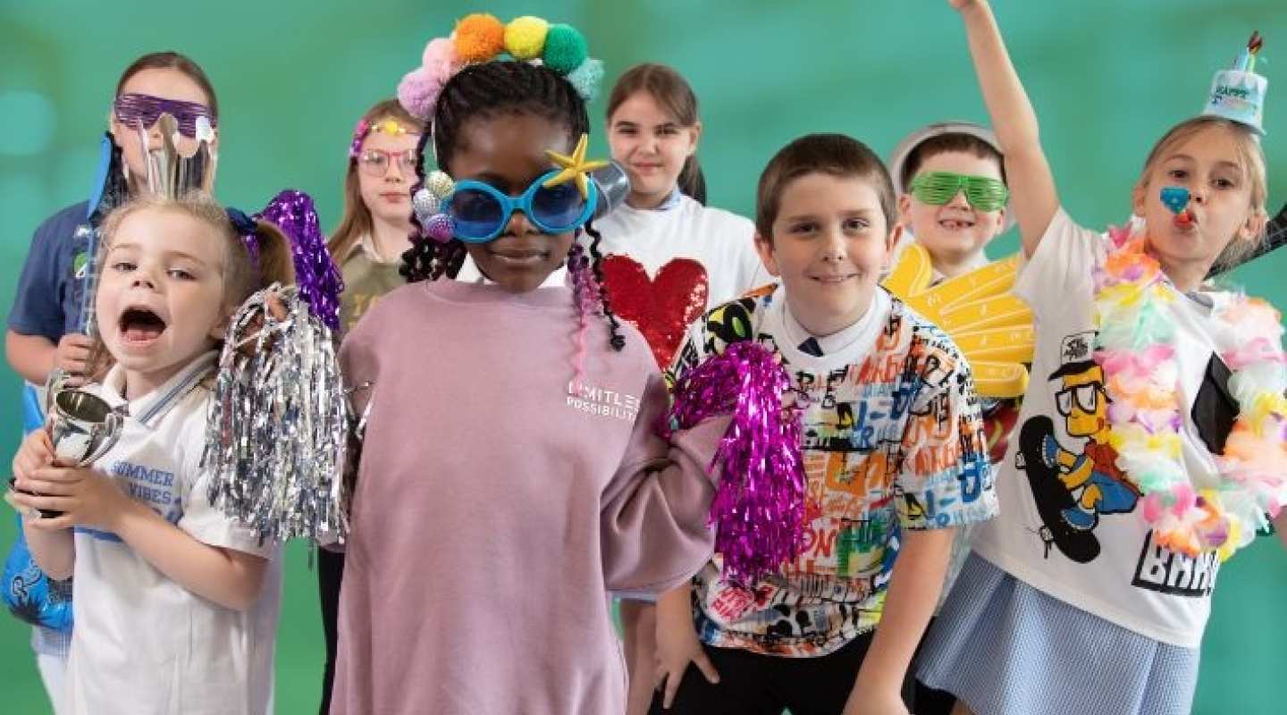 group of children aged 7-9 in party clothes having fun