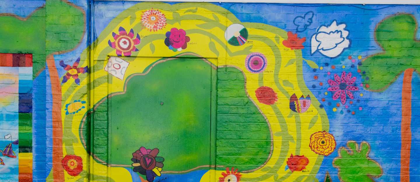 Mural of trees, flowers called Area Of Prosperity by Haffeera Cader Saul and Nightingale Primary School 